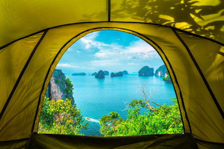 looking from inside the tent to view Phi Phi Island with Maya Bay and Phi Leh Lake, Krabi Province, a rocky tropical island isolated with turquoise water and white beach, Thailand.の写真素材