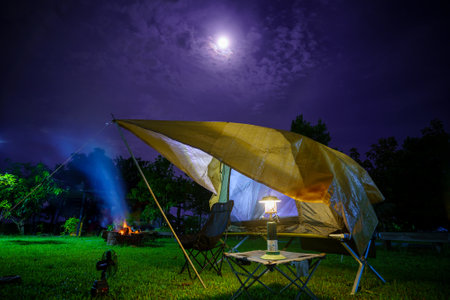 Camping tents at night in a forest Sky background with the moon, Antique lanternsの写真素材