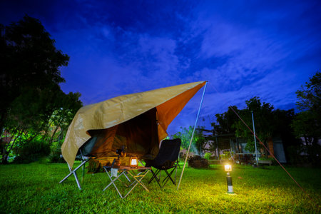 Camping tents at night in a forest Sky background with the moon, Antique lanternsの写真素材