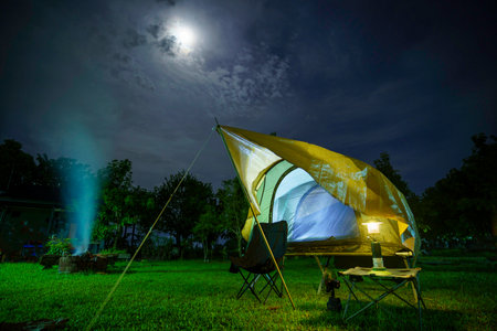 Camping tents at night in a forest Sky background with the moon, Antique lanternsの写真素材