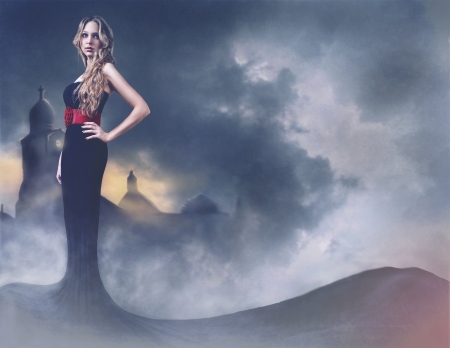 beautiful girl in evening dress on a background of the castleの写真素材