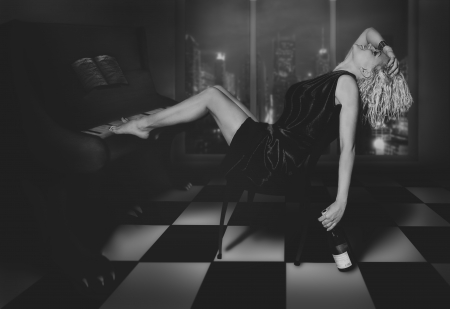 curly blonde sitting at the piano with wineの写真素材