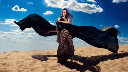 sweet woman in long dress in desertの写真素材