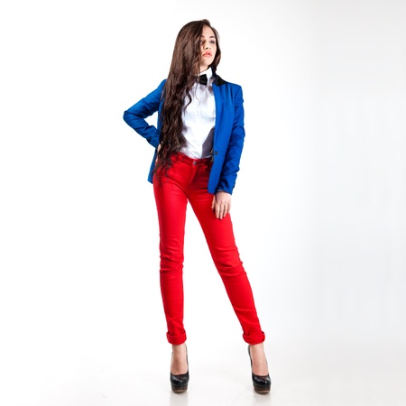 sweet young woman in red pants and blue coat の写真素材