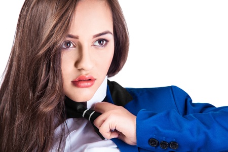 Portrait of young beautiful girl in blue coat and bow-tie の写真素材