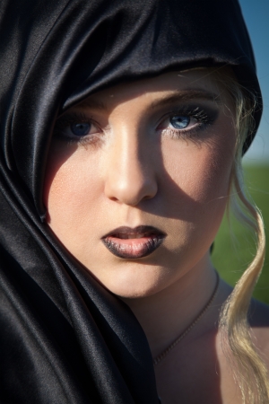 lovely girl with blue eyes outdoors looking at cameraの写真素材