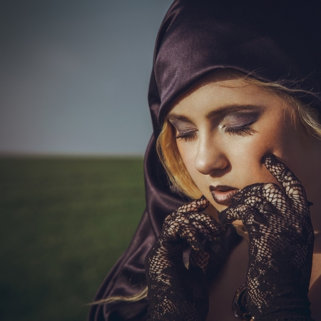 pretty young blonde with closed eyes outdoors in the fieldの写真素材