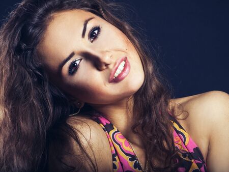 Pretty young woman smiling on camera in studioの写真素材