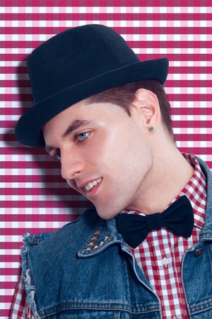 Adult caucasian man in studio near checkered wall in studio の写真素材