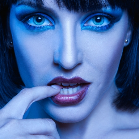 Cold tones close up portrait of sweet brunette in studioの写真素材