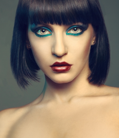 Sexy brunette in studio on gray background looking at cameraの写真素材