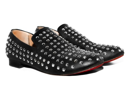 shoues with spikes and red sole in studio on white backgroundの写真素材