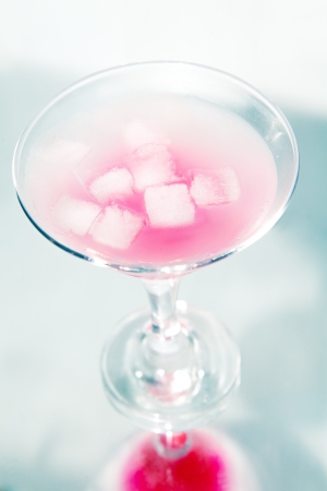pink cocktail with ice and reflaction in studioの写真素材