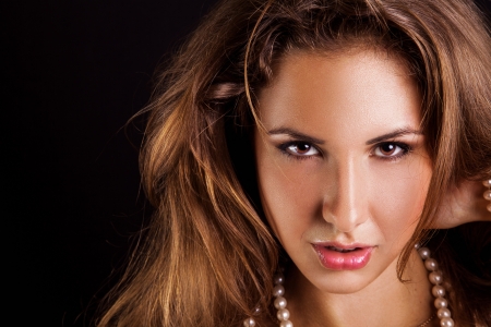 Caucasian adult woman looking at camera in studio on black backgroundの写真素材