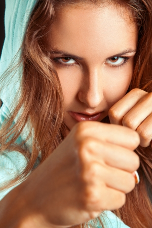 Close up portrait of caucasian woman in boxing stance in studioの写真素材