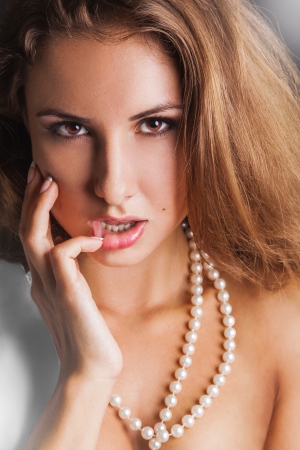 Sensual woman with brown eyes looking at camera in studioの写真素材