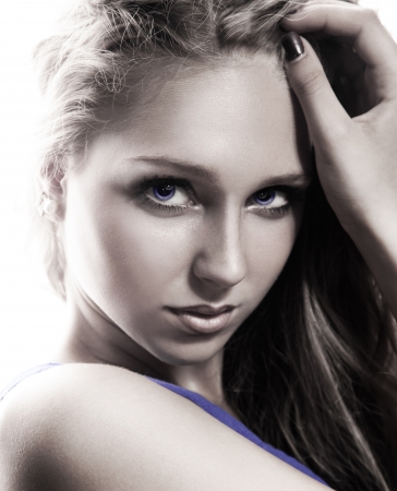 Close up portrait of young girl in muted tones in studioの写真素材