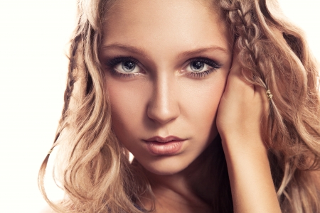 Pretty young girl looking at camera on white background in studioの写真素材