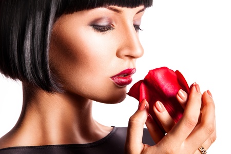 Attractive woman with red rose on white backgroundの写真素材