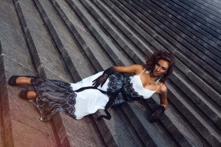Wonderful brown hair woman lying on stairsの写真素材