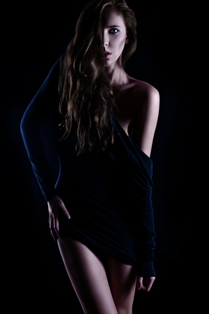 High contrast photo of pretty adult female in studioの写真素材