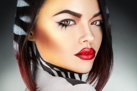 Beauty model with healthy skin looking at camera in studio on gray backgroundの写真素材