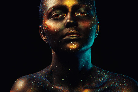 Horizontal portrait of beautiful woman with dark face art in studioの写真素材