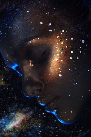 Portrait of pretty adult female with dark face art in studioの写真素材