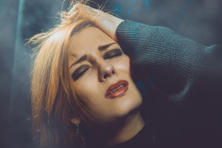 crying woman in studio on black 