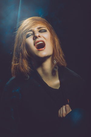Hysteric woman in studio on black の写真素材