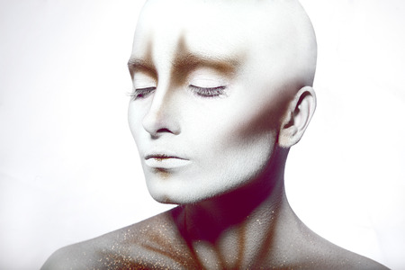 Hairless woman with closed eyes in studioの写真素材