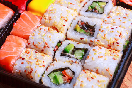 Close up picture of roll california with sesame on tableの写真素材