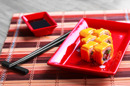 Roll with cheese on red plate on tableの写真素材