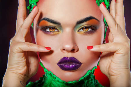 Pretty caucasian girl with creative multicolored makeup in studioの写真素材
