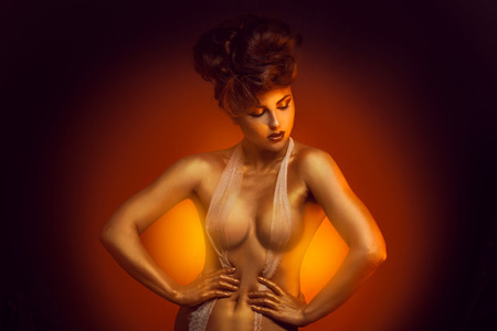 Seductive caucasian adult girl in bandage bra in studioの写真素材