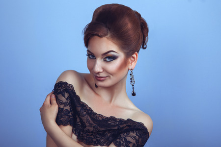 Portrait of glamour young girl with creactive hairstyle and professional make up in studioの写真素材
