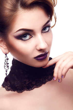 Vertical portrait of serious woman with violet make up in studioの写真素材