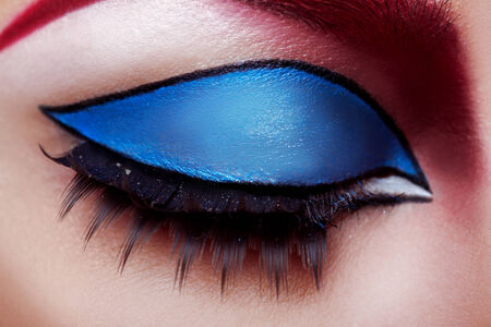 Macro photo of closed womans eye with makeup in studioの写真素材