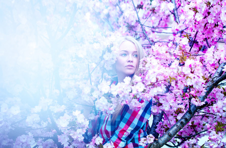 Nice sensual photo of cutie blonde woman in spring with flowers. Spring time