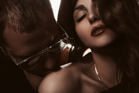Gorgeous couple in studio. Man kissing shoulder of woman. horizontal photoの写真素材