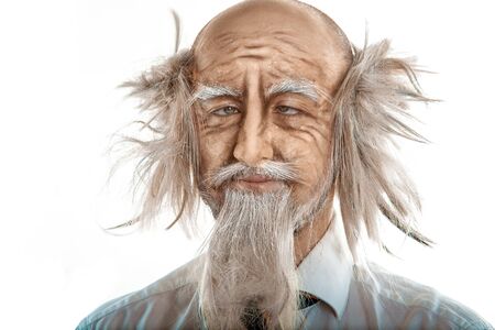 Closeup portrait of crazy oldman on white background in studioの写真素材