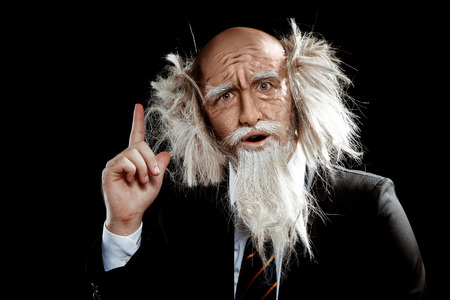 old grandfather had the idea on black backgroundの写真素材