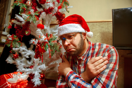 sad nerd celebrates Christmas alone.の写真素材