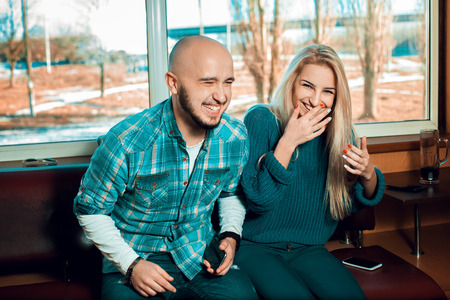 Young beautiful couple having fun and smiling at home