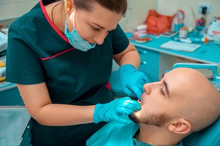 Portrait close up of male at the checkups teeth in dental office