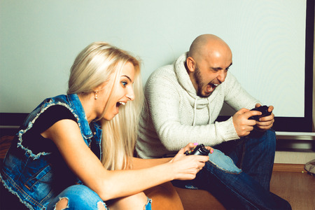 Funny couple playing computer games. concept of leisure entertainment and funの写真素材