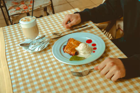 man eating dessert in cafeの写真素材