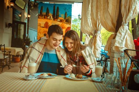 Portrait of young funny couple in love having fun on a date in restaurantの写真素材