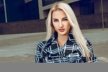 Cutie young adult blonde woman with blue eyes and healthy skin looking at the camera. fashion model...