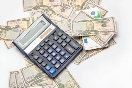 on the white table a lot of money and a calculatorの写真素材